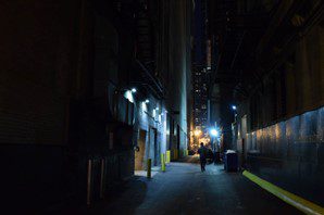 Security services patrolling dark alley